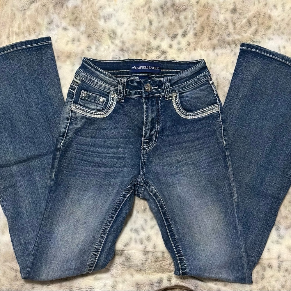 Women's Size 3 bootcut Blue Jeans with bling on back pockets. Has some stretch.